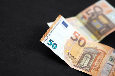 new and old 50 euro banknotes stand on black background,の写真素材