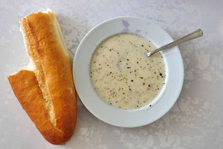 a plate of yoghurt soup and baked bread, Turkish highland soup,