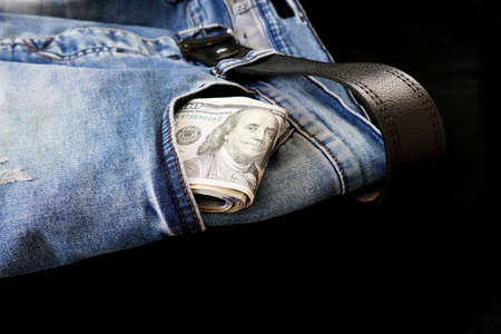 100 usd banknotes visible in the pocket of a jeans lying on the floor, your jeans and 100 usd,の写真素材