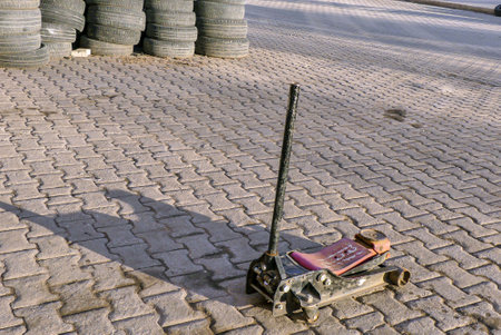 automobile tire repair shop, worn tires and jack in the tire shop,の写真素材