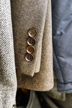 the cufflinks of the jacket hanging in the closet are visible,close-up coat-jacket,の写真素材
