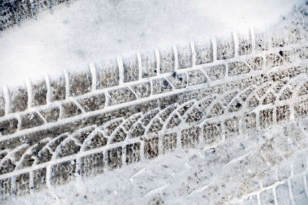 automobile ruts prominently formed on the snow,