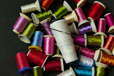 close-up there are lots of colorful spools of thread, thick sewing thread, big needle,の写真素材