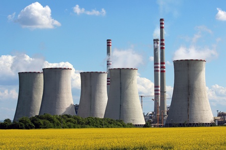 view of coal power plant over yellow agriculture field view of coal power plant over yellow agriculture field