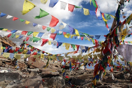 colourfull praying buddhist flags under cloudy sky