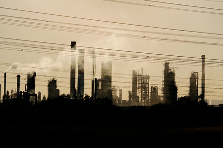 view of oil crude refinery against the sunlight