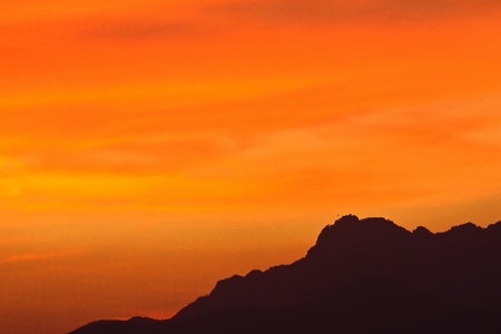 Silhouette of ridge by sunsetの写真素材