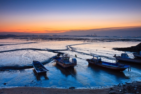 Landscape of mud flat with boats by twilightの写真素材