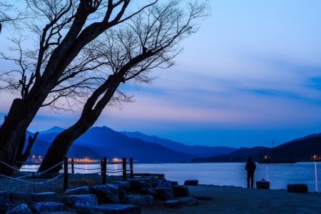 Fishing at riverside by twilightの写真素材