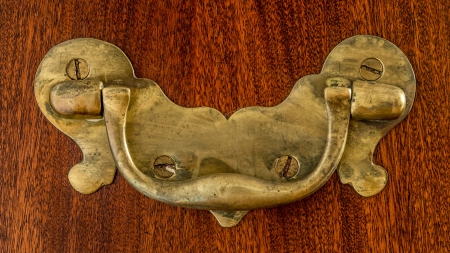 old unpolished brass handle with lots of patina on fine polished wood の写真素材