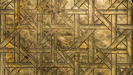Abstract  ruler like  pattern in brass with patina