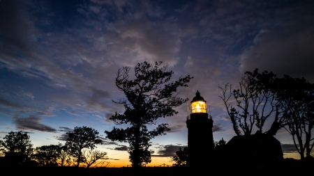 lighthouse by during a Scandinavian midsummer midnight on the island of Bornholm in silhouetteの写真素材