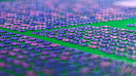 purple puzzle pieces neatly sorted on a green table clothの写真素材