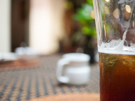 Close up of a glass of beer on a table in a cafeの写真素材