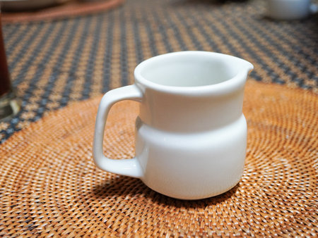 Cup on a rattan tableclothの写真素材