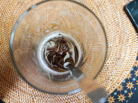 Coffee in a glass cup on a straw tablecloth.の写真素材