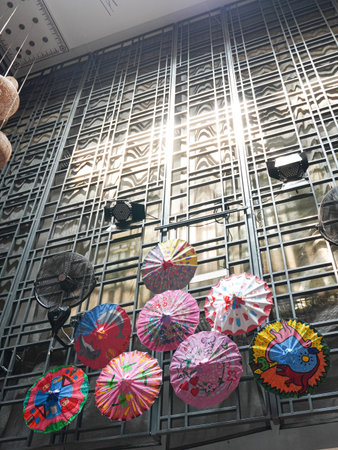 Colorful umbrellas hanging from the ceiling of a building.の写真素材