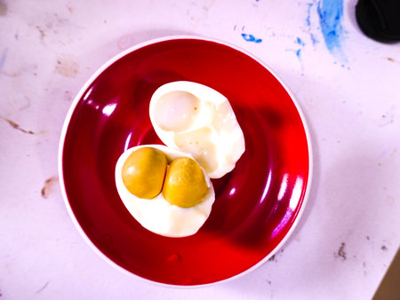 Boiled egg in red plate on white background.の写真素材