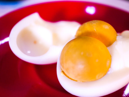 Boiled eggs on a red plate. Close-up, selective focus.の写真素材