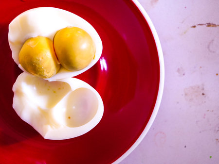 Boiled eggs on a red plate, top viewの写真素材