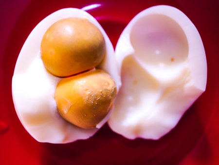 Boiled eggs on a red plate, shallow depth of field.の写真素材