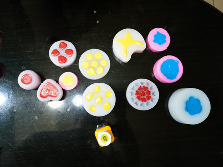 Colorful wax candles on black tableの写真素材