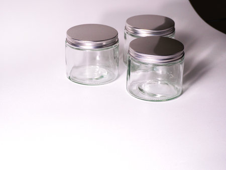 Empty glass jars on a white background with copy space. Top view.の写真素材