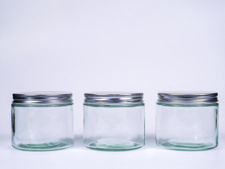Empty glass jars isolated on white background. Clipping path included.の写真素材