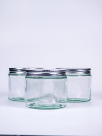 Empty glass jars on a white background. Close-up shot.の写真素材