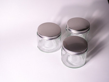 Three glass jars on a white background. Close-up.の写真素材