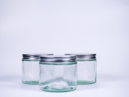 Empty glass jars on white background with copy space for your text.の写真素材
