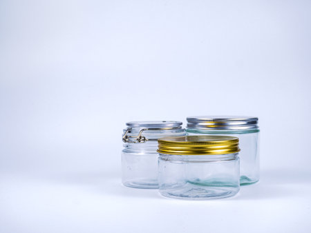 Jars of different sizes on a white background, close-upの写真素材