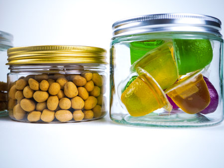 Jars filled with candies on white backgroundの写真素材