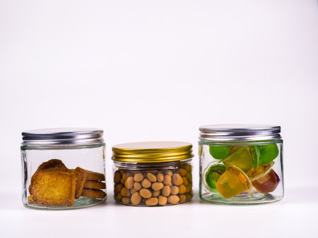 Jars of different snacks on a white background with copy spaceの写真素材