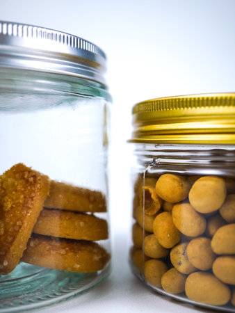 Cookies in a glass jar on a white background. Selective focus.の写真素材