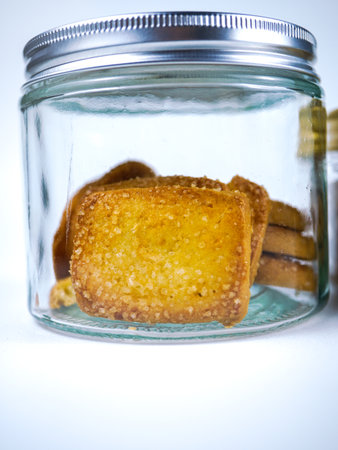 Crispy crackers in a glass jar on a white backgroundの写真素材