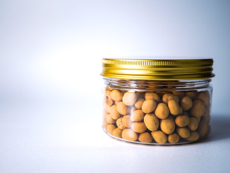 Canned chickpeas in a glass jar on a white backgroundの写真素材