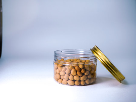 Glass jar with chickpeas on a white background. Copy space.の写真素材
