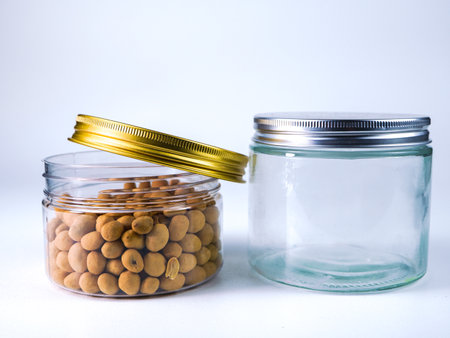Glass jars with soybeans on a white background.の写真素材
