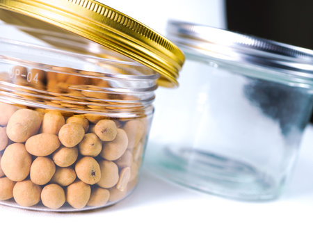 Soybean in a glass jar on a white background close upの写真素材