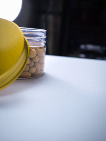 Glass jar with chickpeas on the table in the kitchen.の写真素材