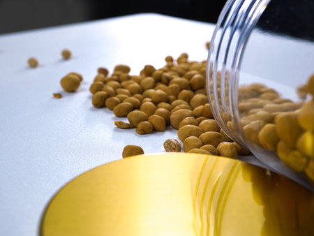 Beans in a glass jar on a white background. Beans are scattered on the table.の写真素材