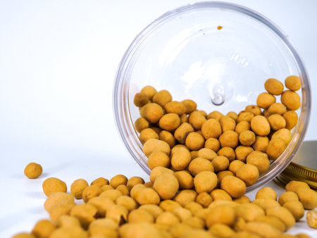Crispy peanuts in a glass jar on a white background.の写真素材