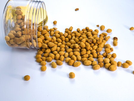 Seeds in a glass jar on white backgroundの写真素材