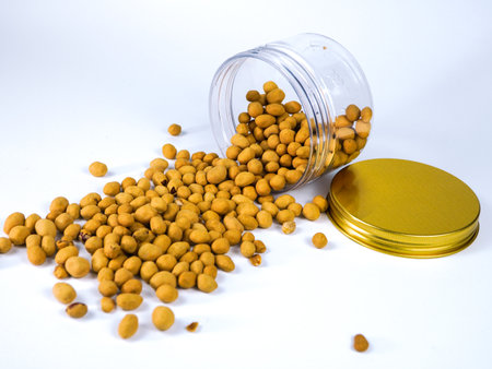 Fertilizer in a glass jar on a white background.の写真素材