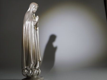 Statue of the Blessed Virgin Mary with the shadow of Jesus Christの写真素材