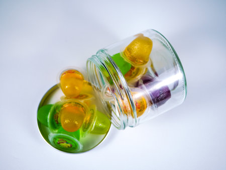 Jelly candies in a glass jar on a white background.の写真素材