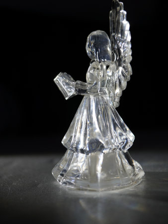 Ceramic statuette of an angel on a black backgroundの写真素材