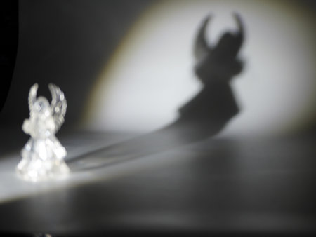 Silhouette of angel on white background with shadow and light.の写真素材