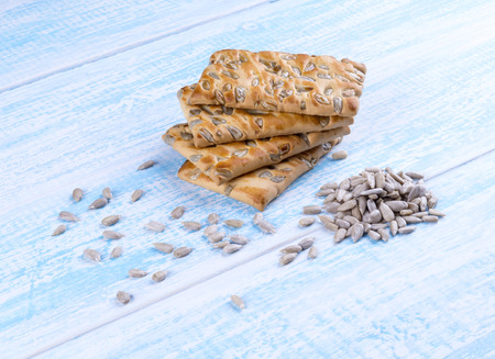 cookies with sunflower seeds on blue wooden tableの写真素材